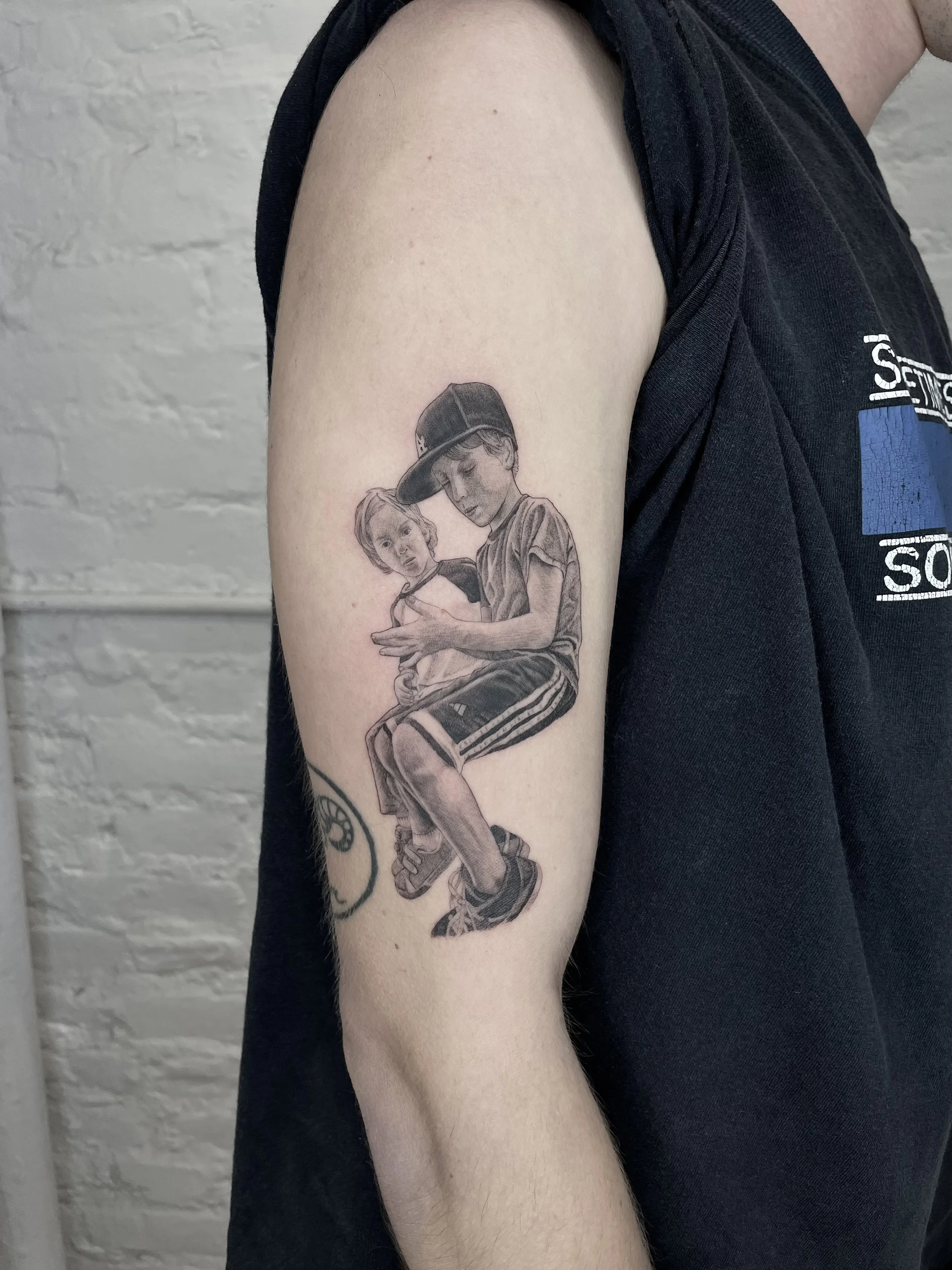 single needle family portrait tattoo