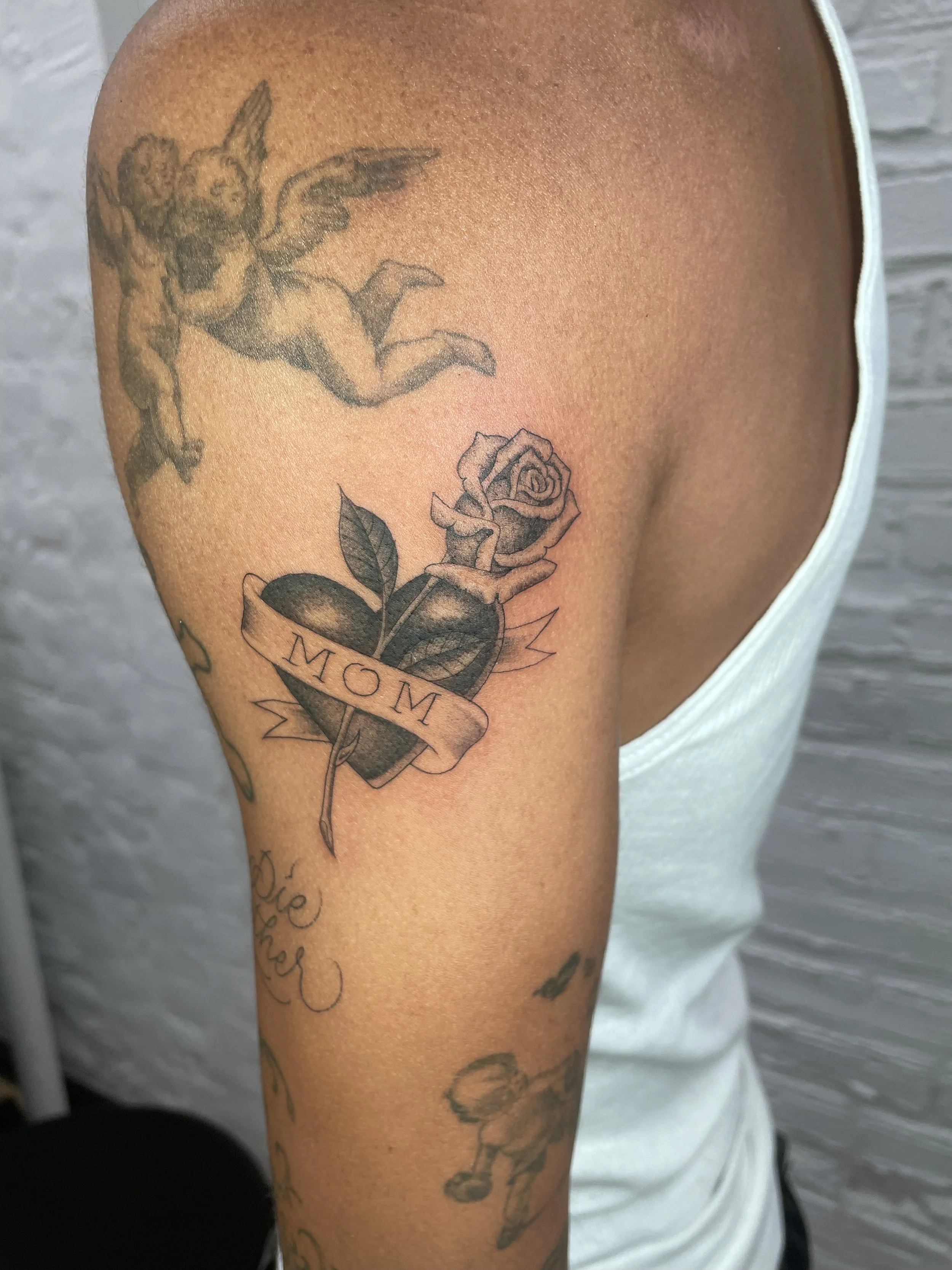 mom heart with a rose tattoo done on lil dre