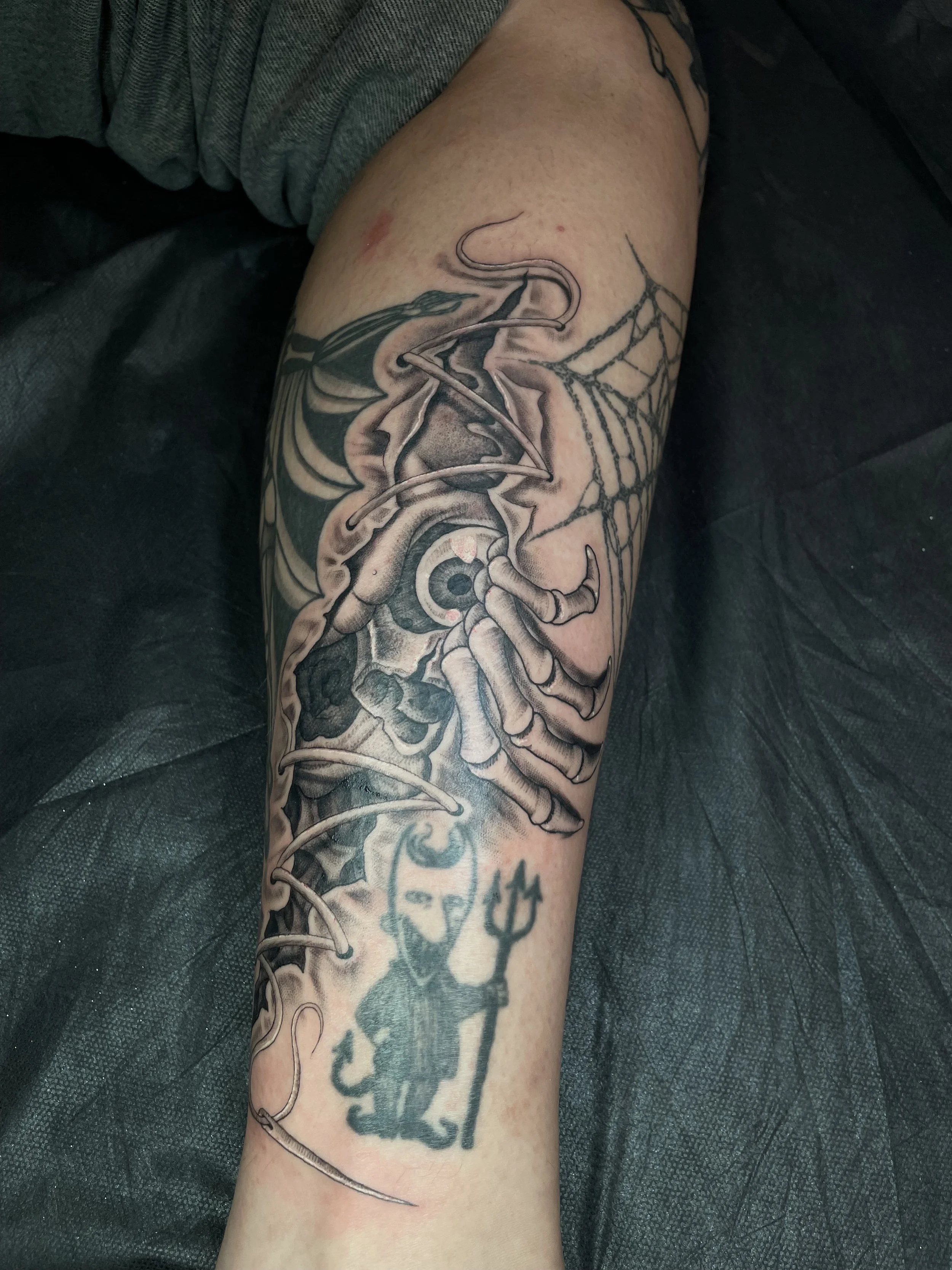 skin rip skull tattoo on the leg