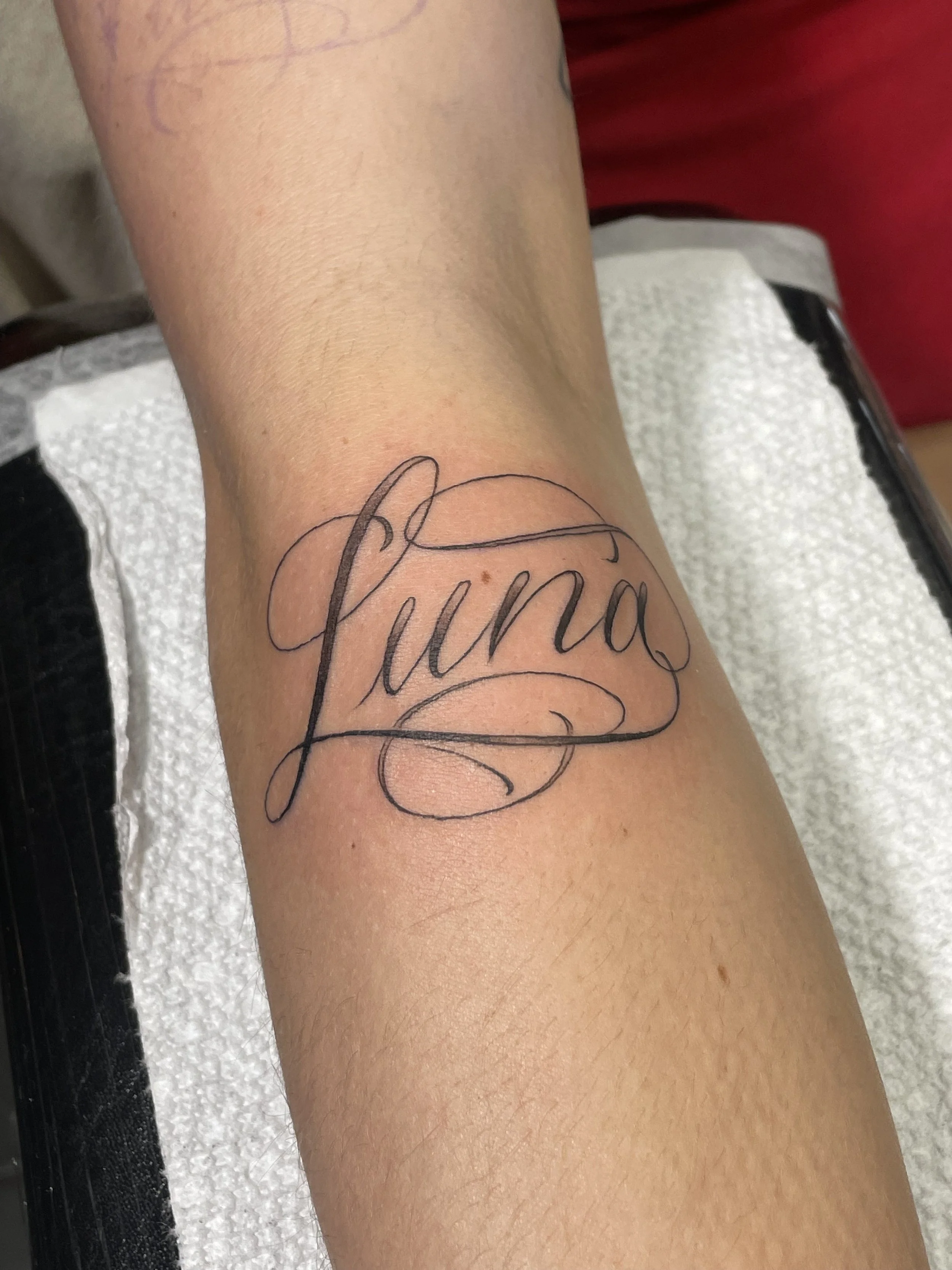 letting tattoo of simple script.jpeg
