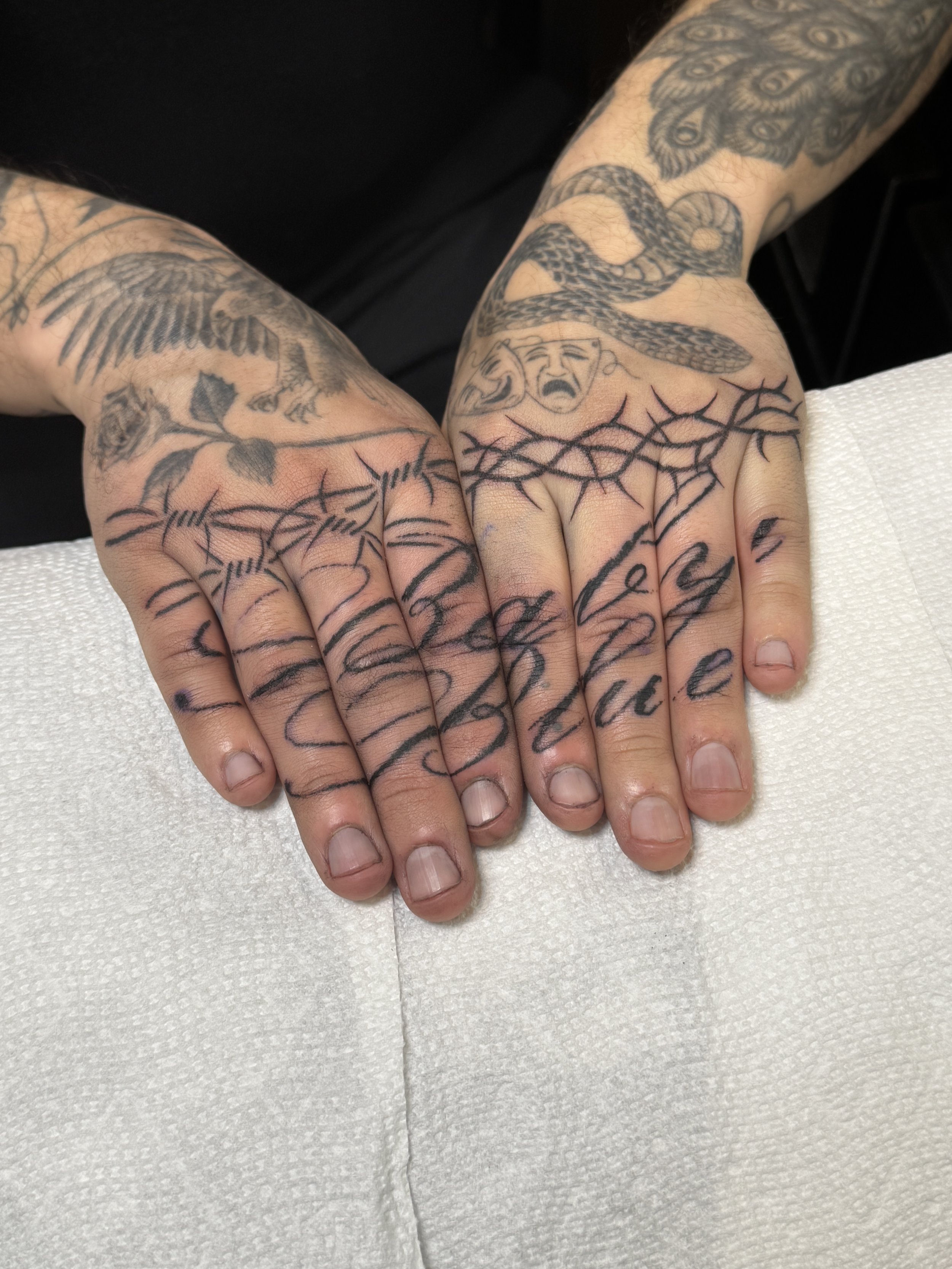 blackwork thorns and script knuckles tattoo