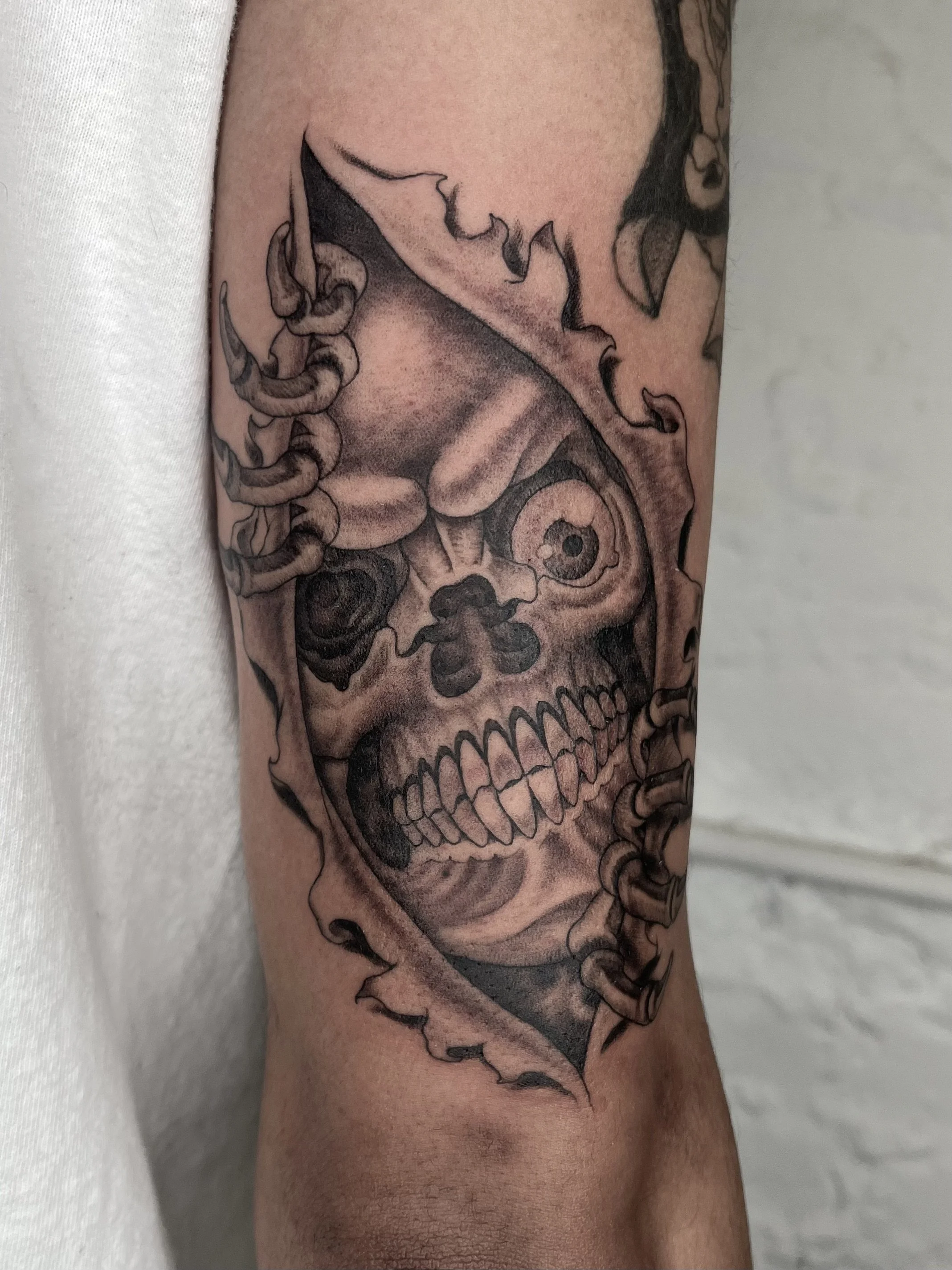 skull skin rip tattoo