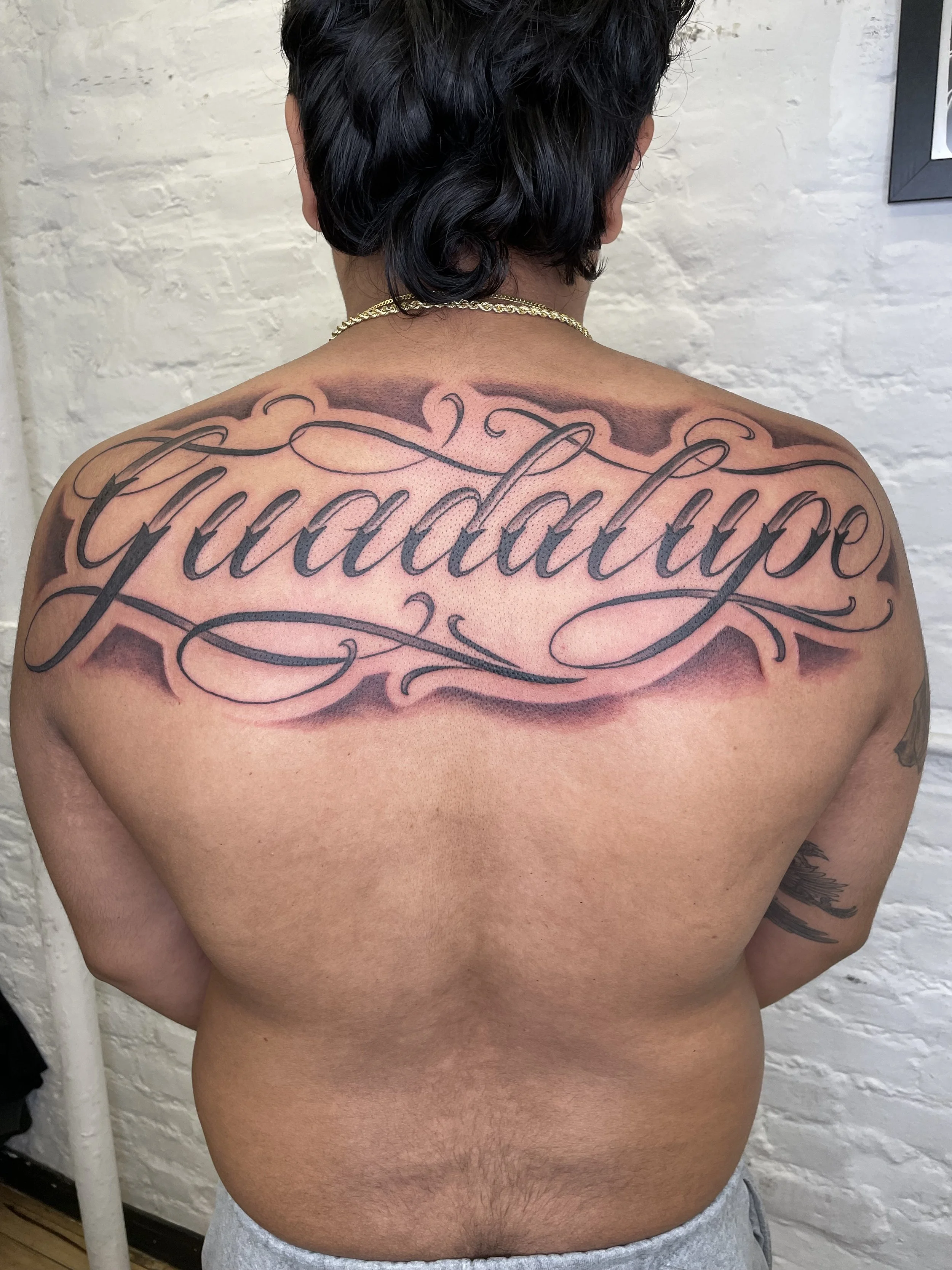 letting tattoo guadalupe on back .jpeg