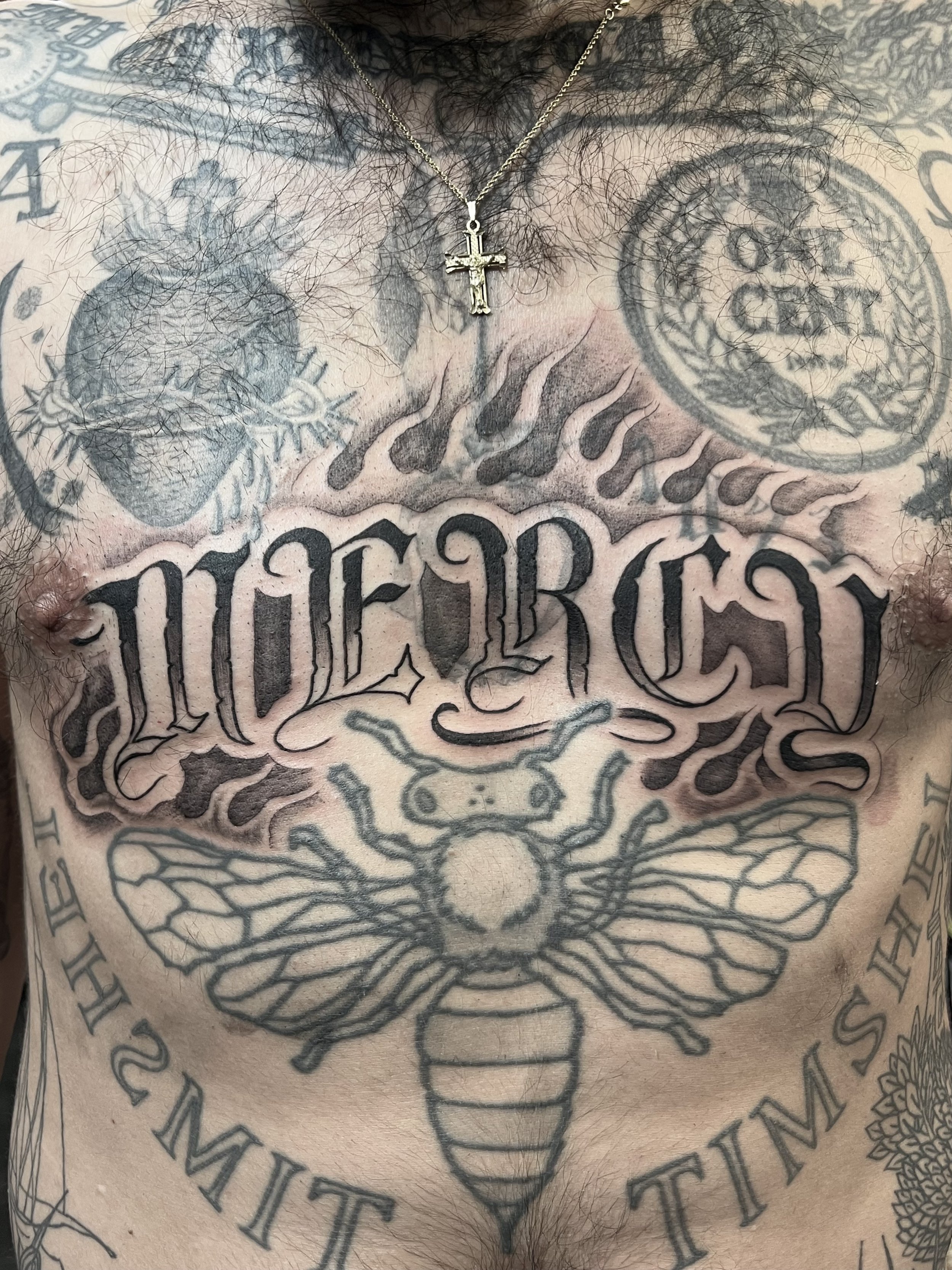 mercy gothic lettering stomach tattoo.jpeg