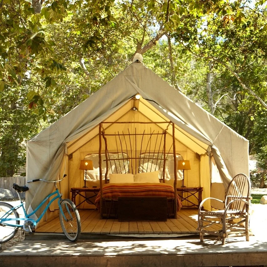 PRIVATE TENT | QUEEN BED W/ SHARED BATH Features: Shared Bath, Nature Views, Screen windows, Bedside tables, chairs, a small desk, Small heater and electric lamps, outdoor picnic table & firepit