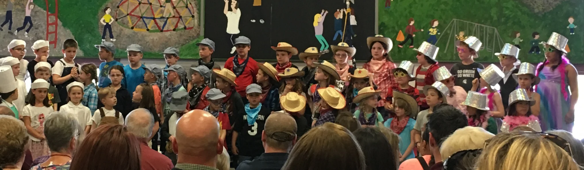 Monkey Boy’s spring performance. He’s one of the movie stars in the glittery silver hat on the top row.