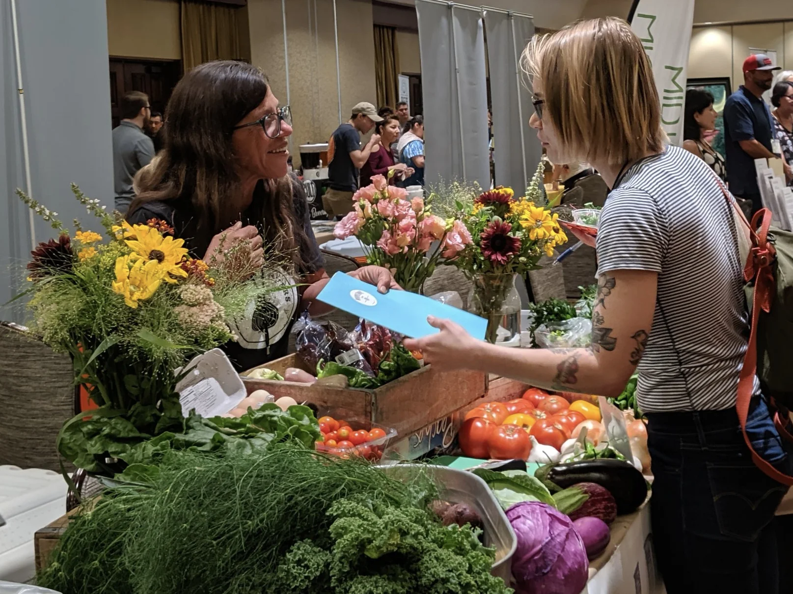 There’s no local food without local growers. Shanti Rade from Whipstone Farms shares her story with a potential customer.