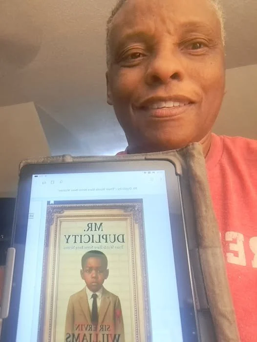 KIM CUZZ HOLDING BOOK.jpg