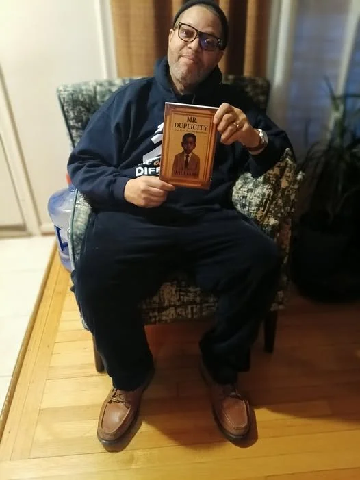 ELAM HOLDING BOOKS.jpg