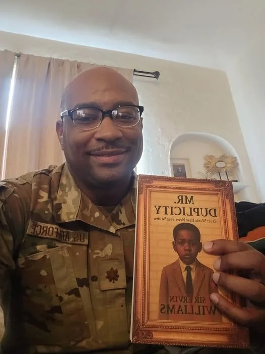 DONALD HOLDING BOOK.jpg