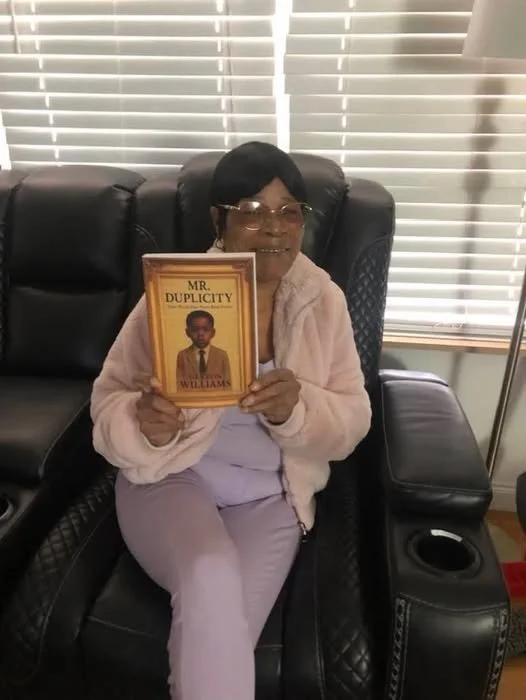 Monwella holding the book.jpg
