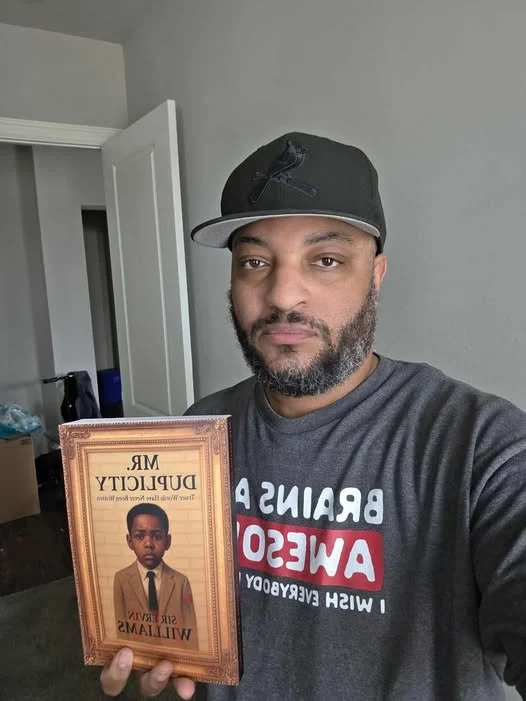 tony holding the book.jpg