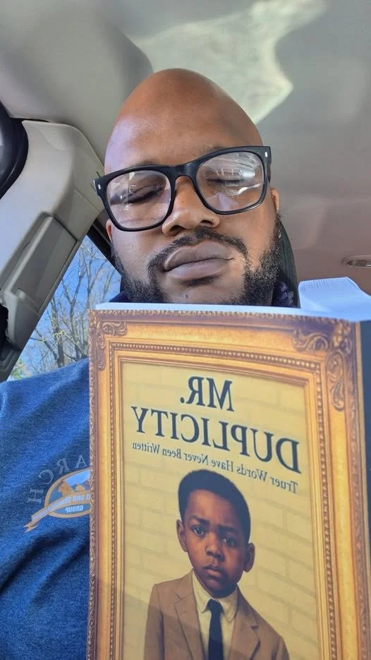 chris holding book.jpg
