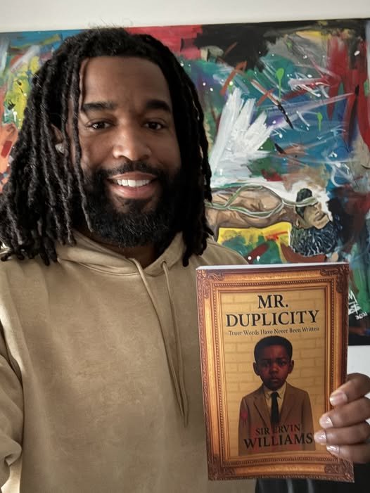 maal holding book.jpg