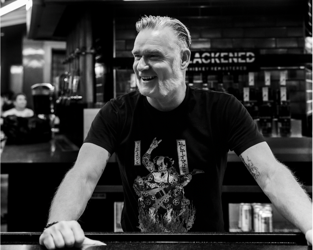 rob dietrich standing at a bar smiling