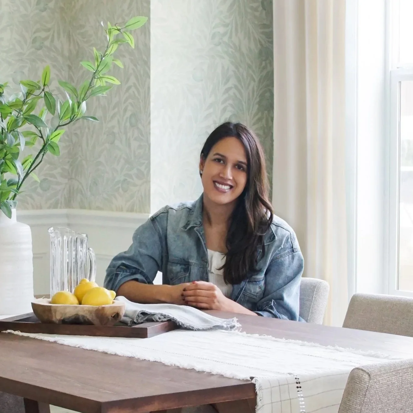 Santa Monica interior designer Nita Tandon of Tandon Interiors in a dining room with patterned textiles and custom wood dining table