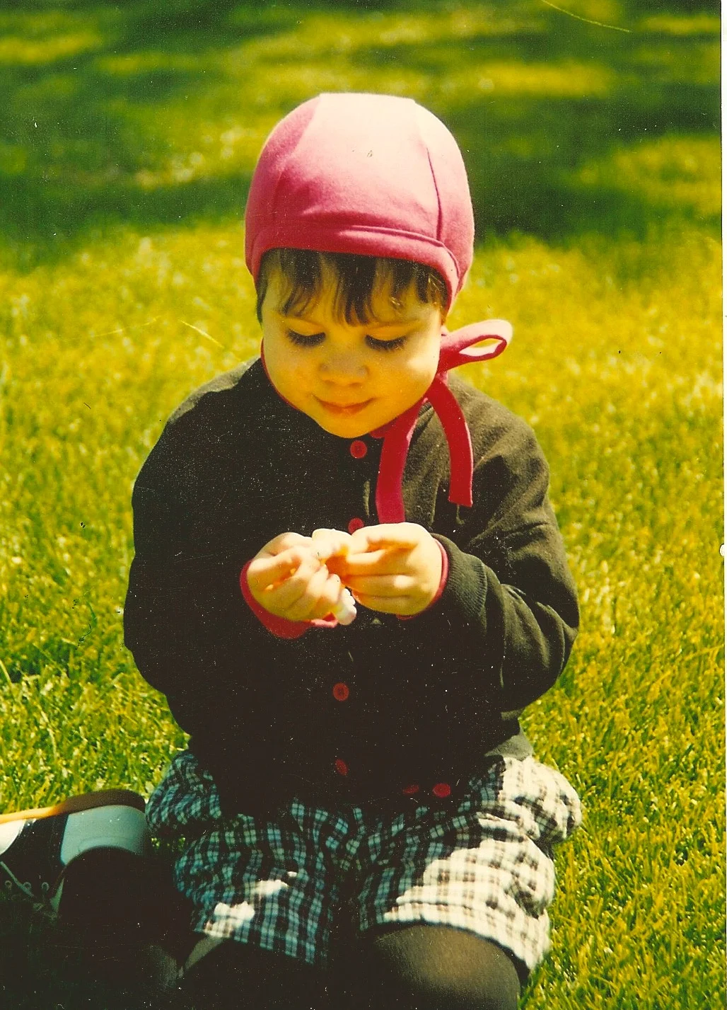 1990 - JoJo . age 2 playing with a walnut, wearing an Earhart Pilot in Size Large - fuscia organic cotton from Spiritex Mills, Asheville, NC. a great US manufacturer of organics. We support!! Most Age 2 children wear XL, or XXL with revised sizing. Also revised: our ties are thin.