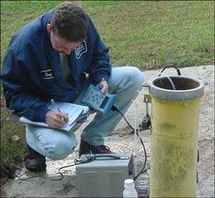 A technician takes a groundwater sample.