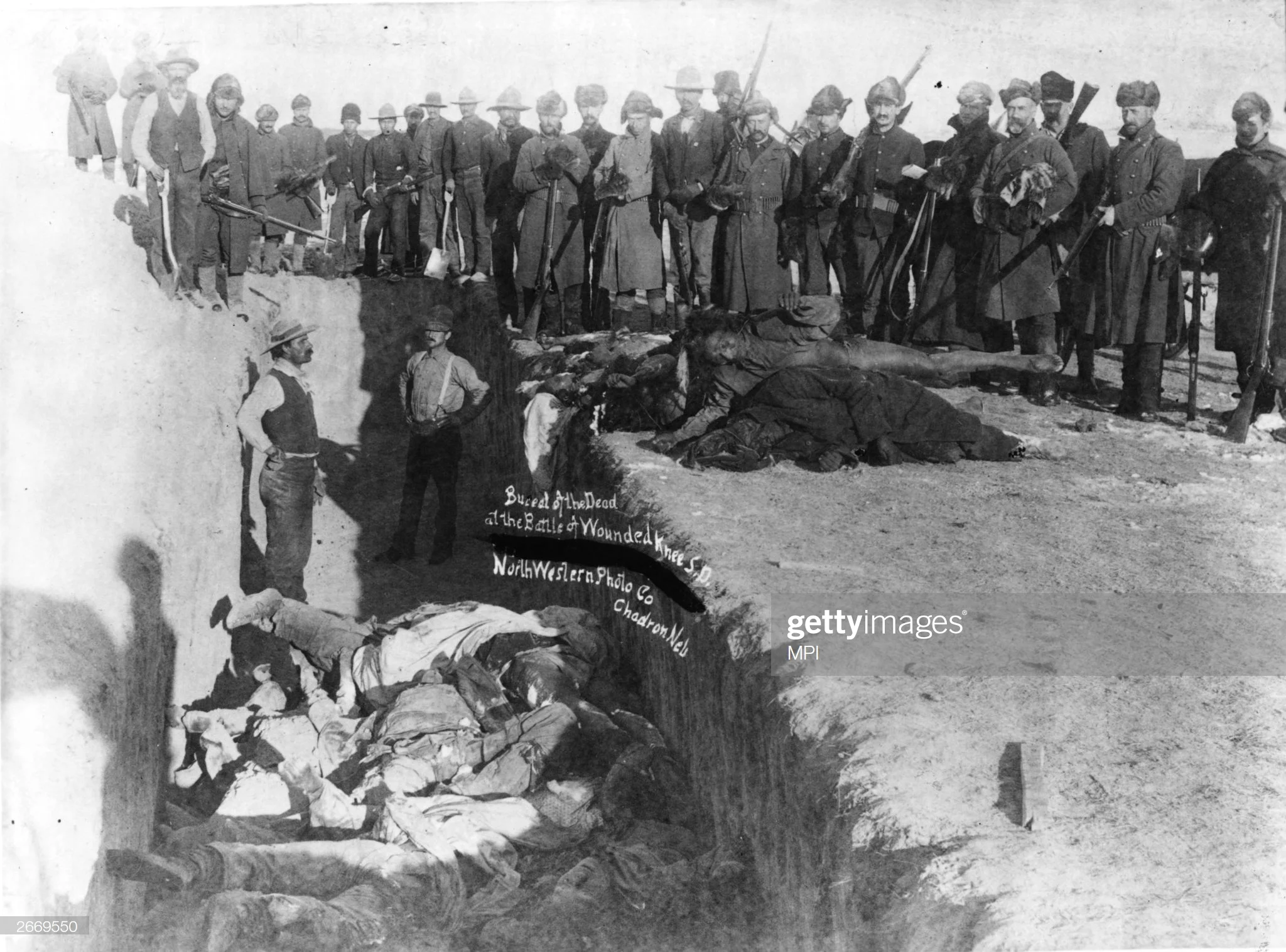 december-1890-bodies-of-sioux-indians-being-unceremoniously-piled-a-picture-id2669550.jpg