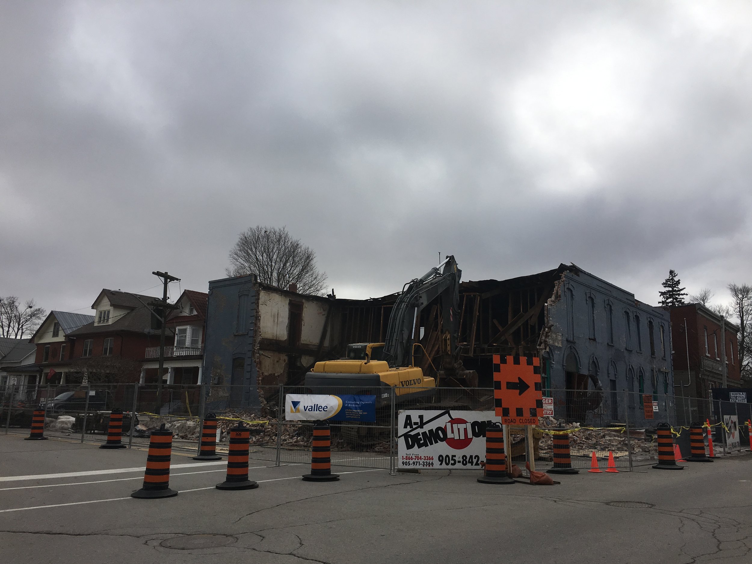 In the first photo, Jenn & Emily stand in downtown Simcoe near the corner of Talbot and Robinson back in the fall. Just recently, the former Maliboo Club was demolished by A1 Demolition out of Ancaster; apparently, the owners of the site, Vanderlaan C.S. from nearby Dundas, will build a two-storey structure on the site with apartment buildings and a commercial storefront. The photo on the right shows the demolition in progress.