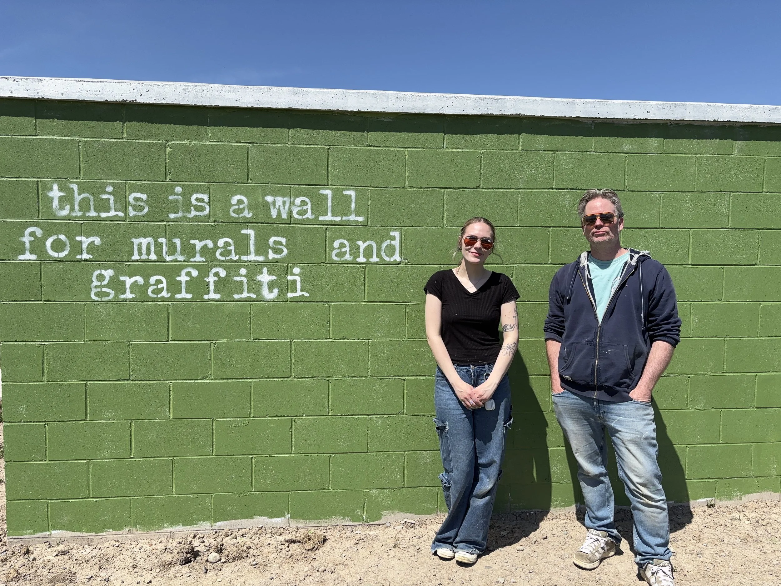      

 
    Photo: Carley Shearon &amp; Andrew Gunn of Andrew Gunn Consulting and  young &amp; free press  stand next to the new ‘Art Wall’ in downtown St. Thomas.      New Wall Installed for Emerging Artists in St. Thomas!   With the exciting growt