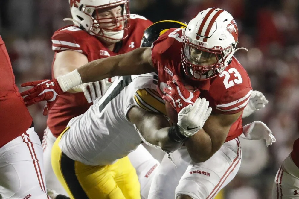 Taylor’s big day helps No. 16 Badgers edge No. 18 Iowa 24-22