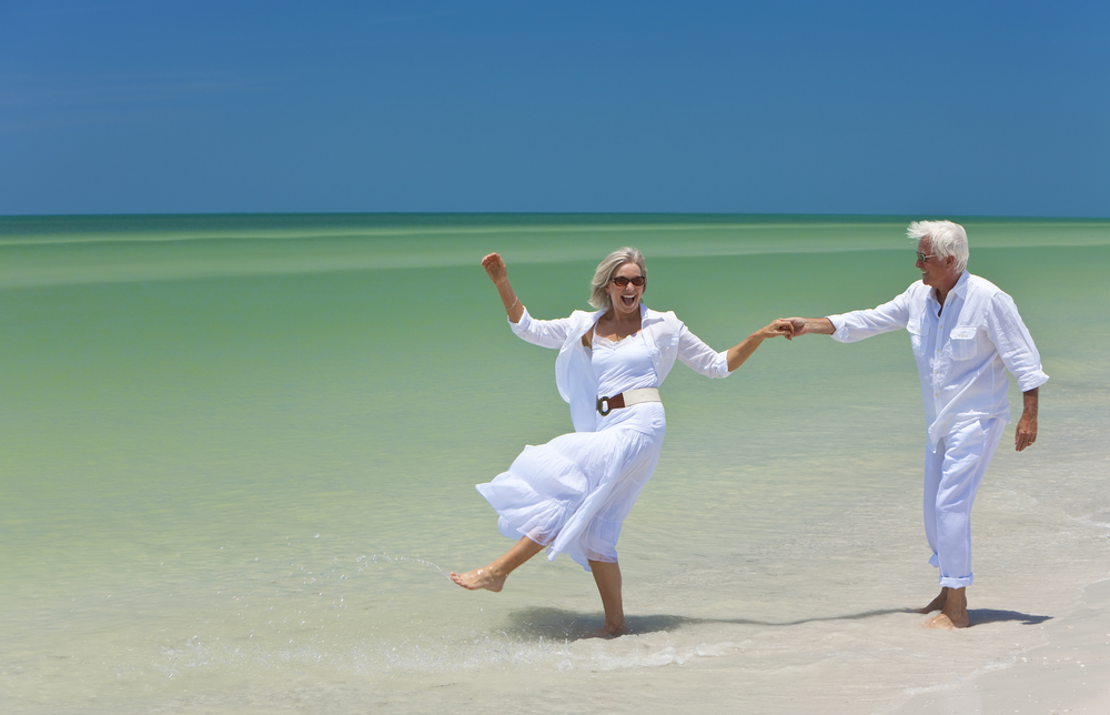 Retirees walking on beach