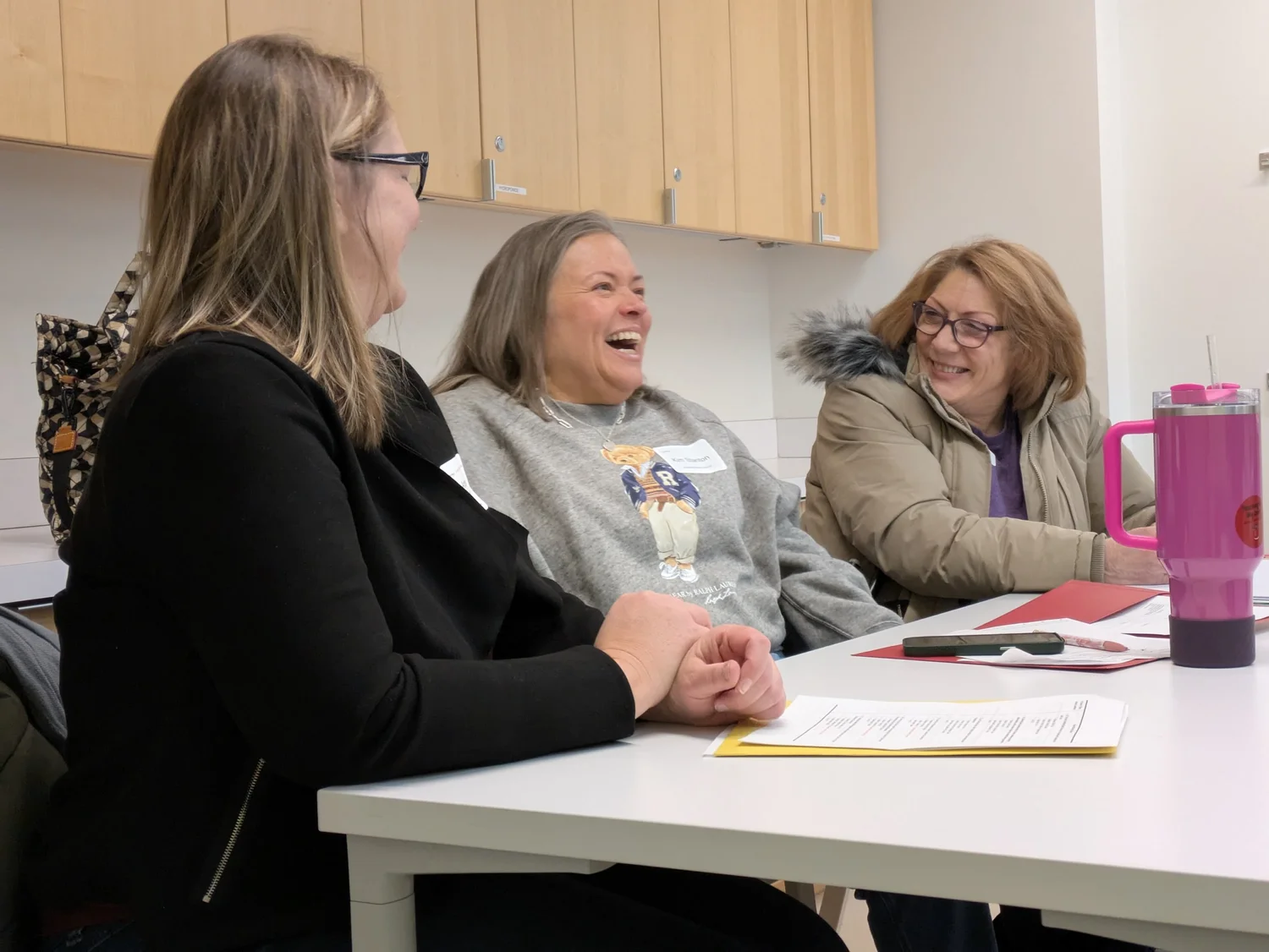 Early childhood educators laughing together at an Alliance workshop