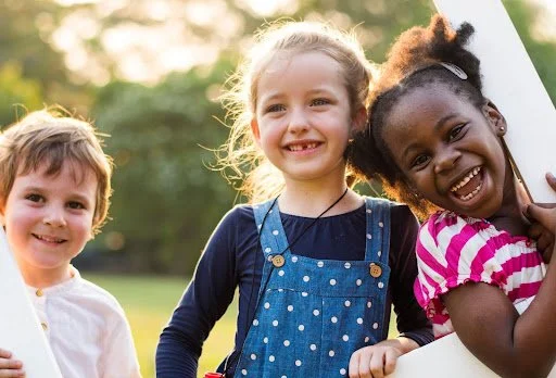 Preschoolers playing together outdoors