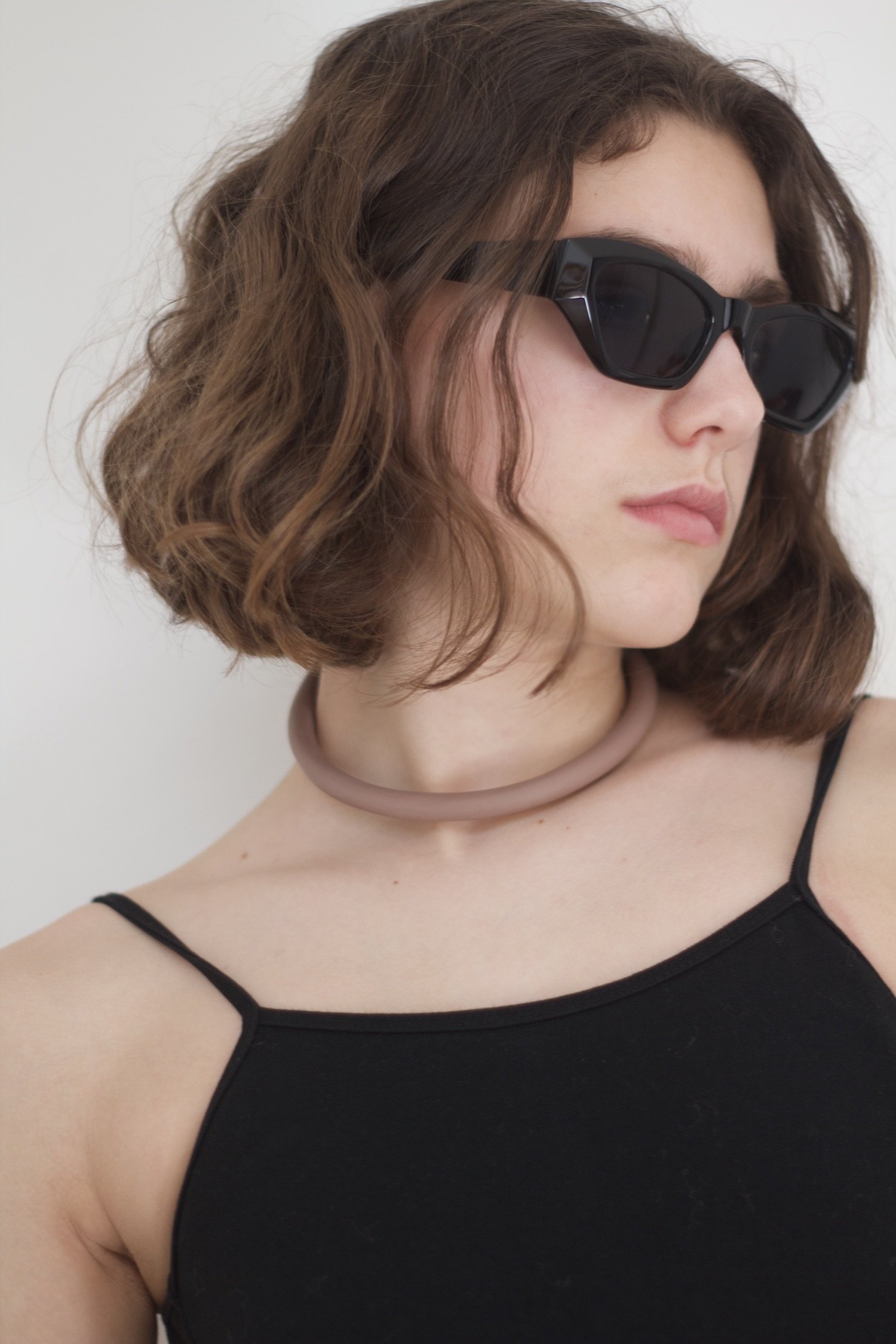 a girls wears her necklace