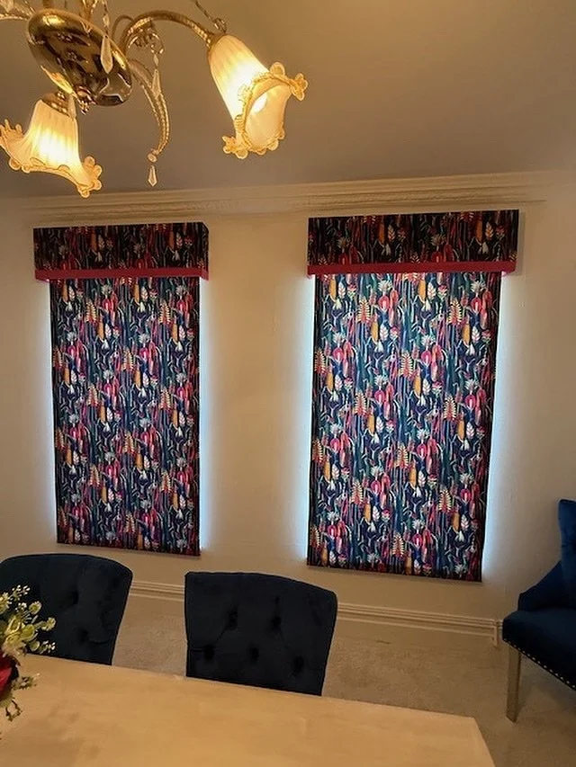 Recent dining room install featuring velvet roman blinds with matching upholstered pelmets, finished with a bold shocking pink contrast edge to define the line between blind and pelmet.
When fully raised, the blinds sit neatly out of sight behind th
