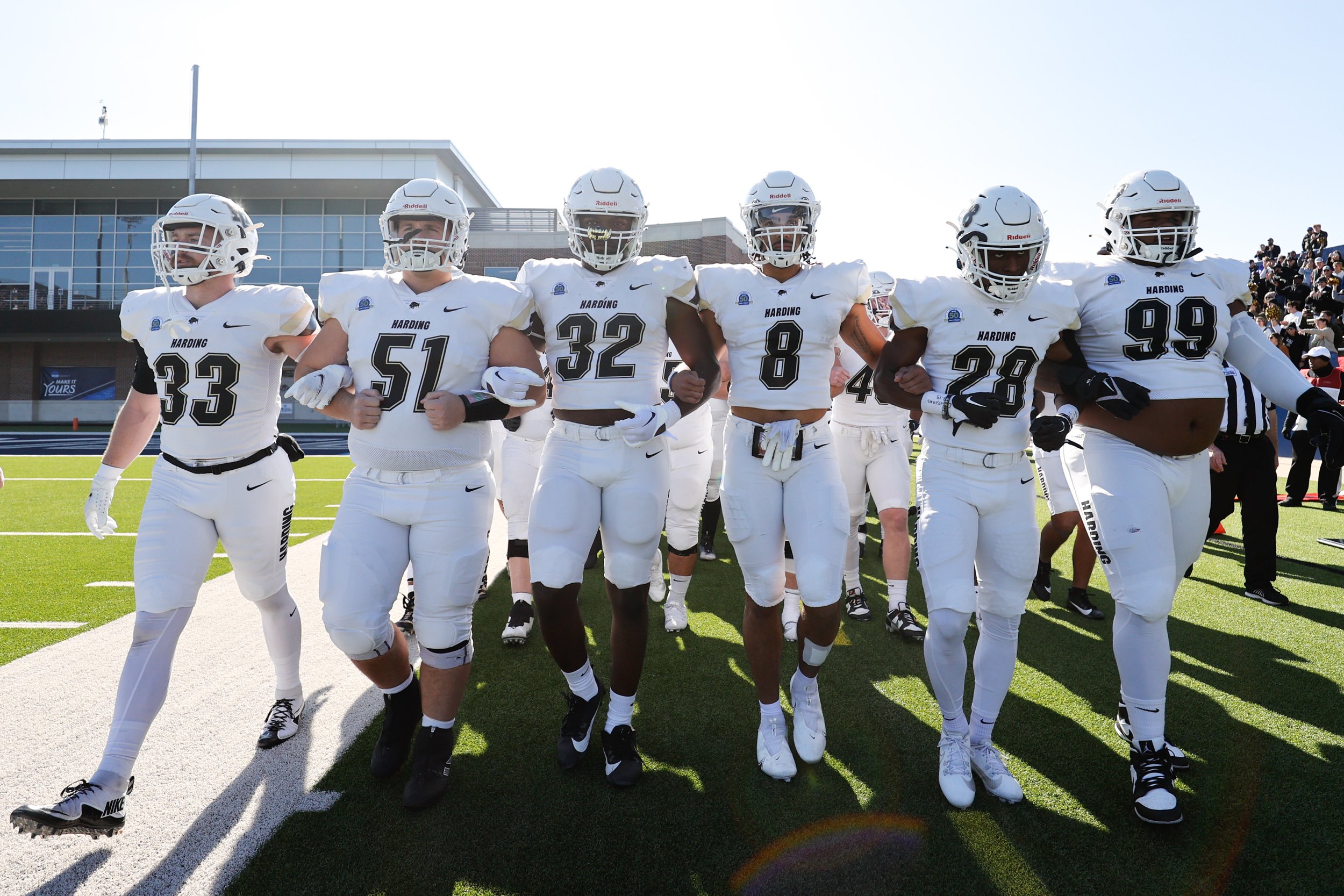  MCKINNEY, TEXAS - DECEMBER 16: Nathaniel Wallace #32 of Harding Bisons with Roland Wallace #8 of Harding Bisons and teammates take the field before the game against the Colorado School of Mines Orediggers during the Division II Football Championship