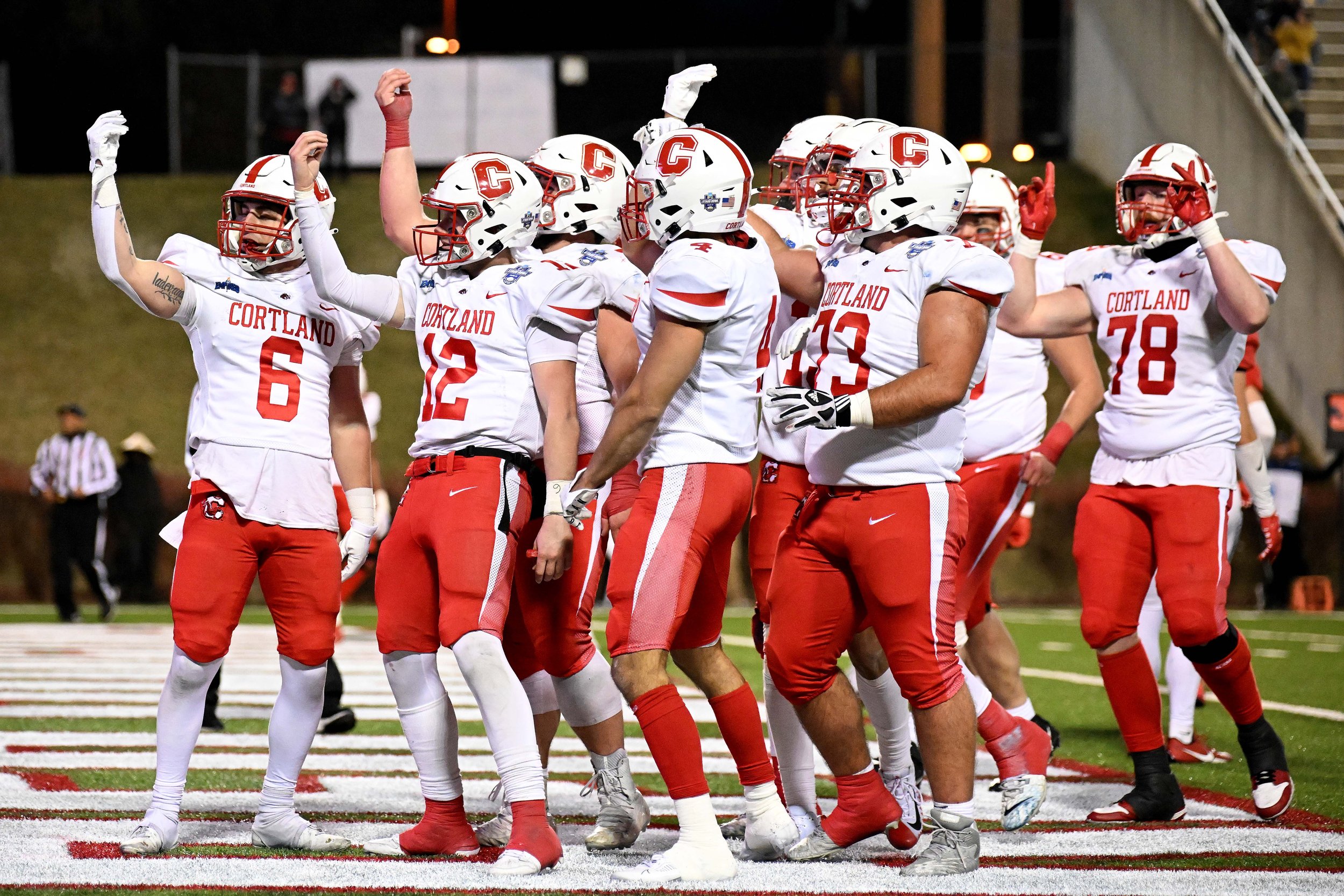  SALEM, VIRGINIA - DECEMBER 15:  Joe Iadevaio #6 of the Cortland Red Dragons celebrates with teammates after scoring a touchdown against the North Central Cardinals during the Division III Football Championship held at Salem Stadium on December 15, 2