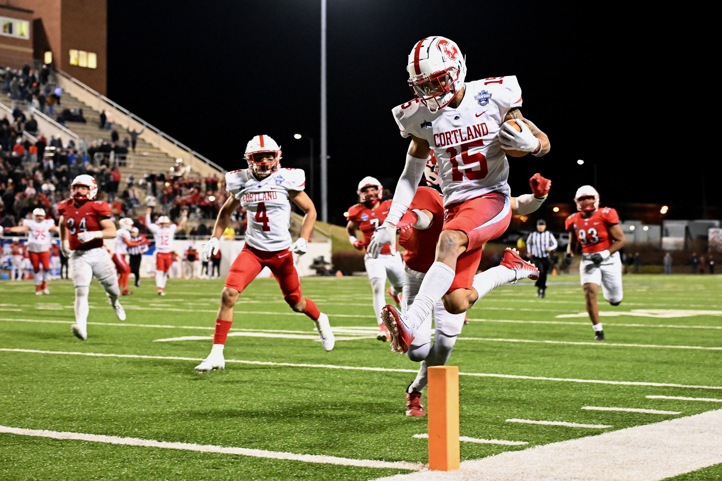  SALEM, VIRGINIA - DECEMBER 15:  Cole Burgess #15 of the Cortland Red Dragons scores the final touchdown against the North Central Cardinals during the Division III Football Championship held at Salem Stadium on December 15, 2023 in Salem, Virginia. 