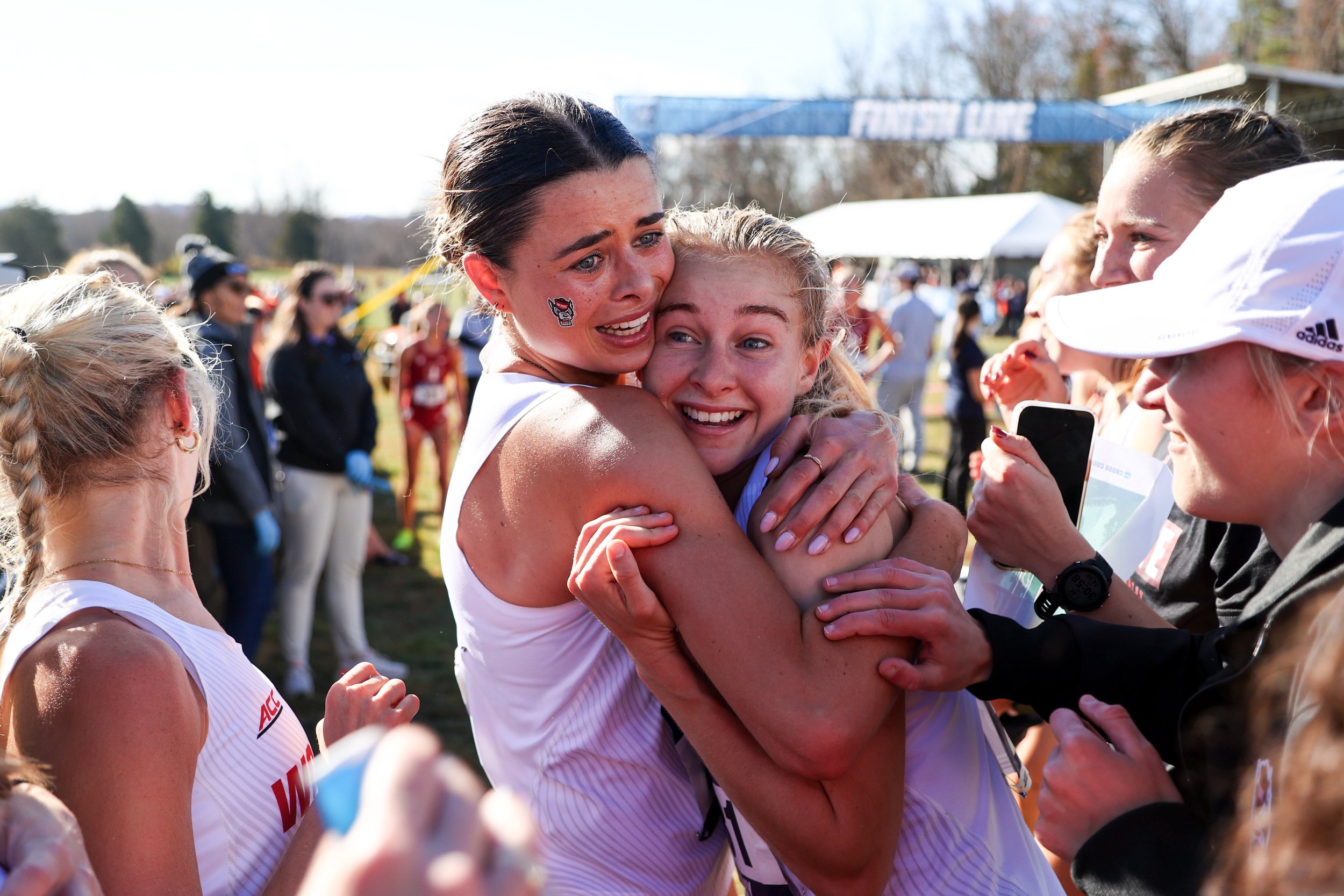  EARLYSVILLE, VIRGINIA - NOVEMBER 18: Hannah Gapes #272 and Katelyn Tuohy #281 of the North Carolina State Wolfpack celebrate after the win during the Division I Men’s and Women’s Cross Country Championship held at Panorama Farms on November 18, 2023