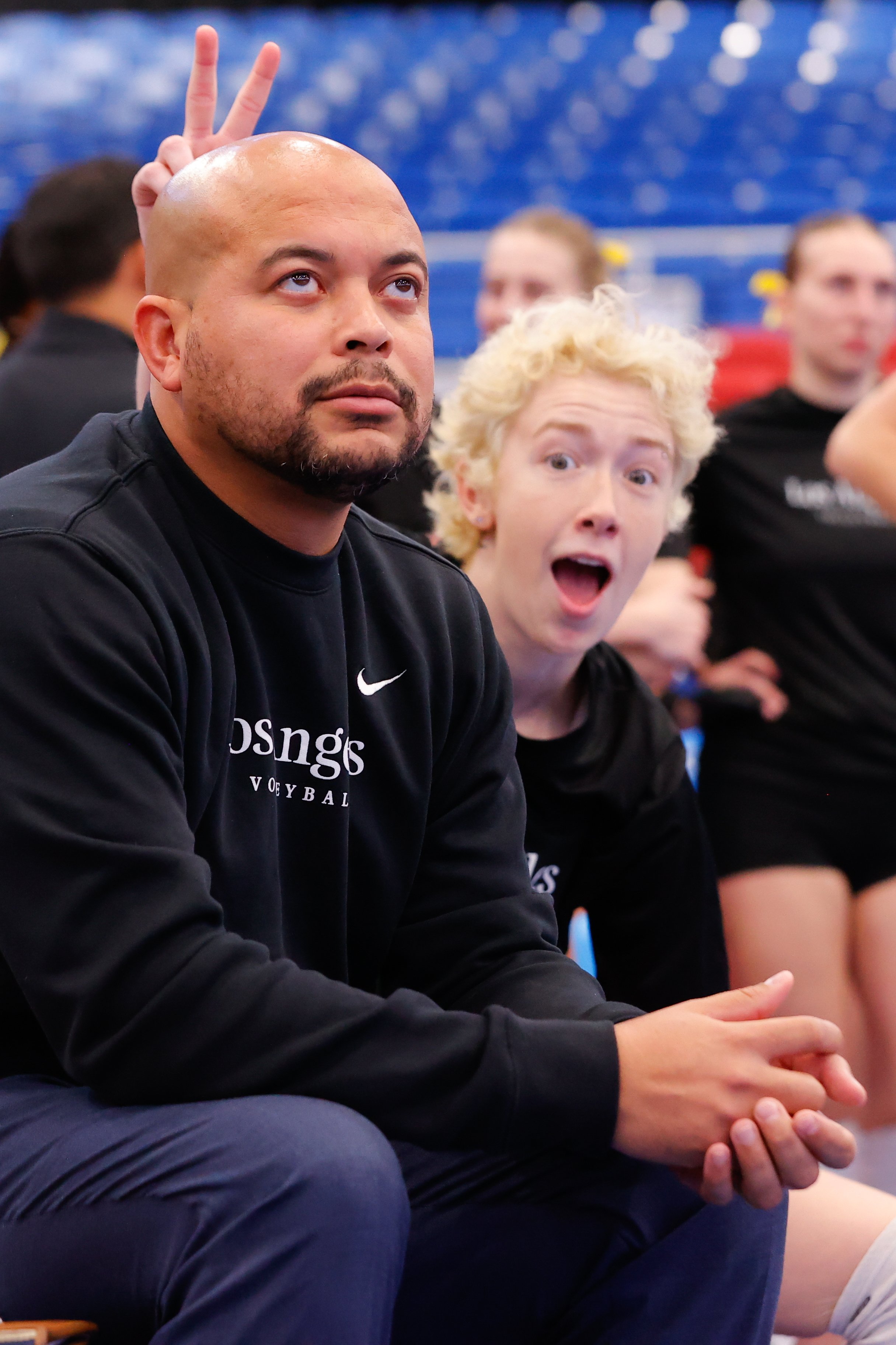  MOON TOWNSHIP, PENNSYLVANIA - DECEMBER 9: Head coach Juan Figueroa of Cal State Los Angeles is photo bombed before the game by Jameson Sanders #14 of Cal State during the Division II Women's Volleyball Championship held at UPMC Events Center on Dece