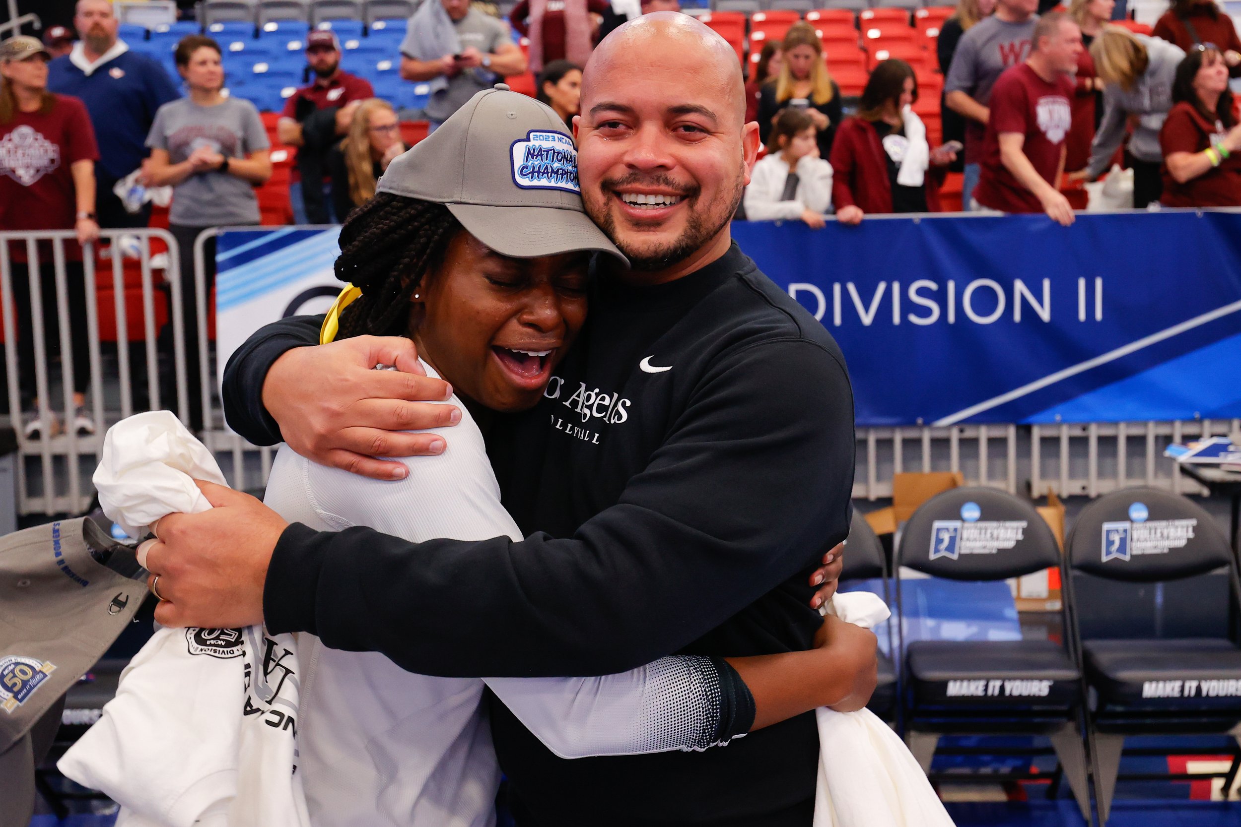  MOON TOWNSHIP, PENNSYLVANIA - DECEMBER 9: Haley Roundtree #11 of Cal State Los Angeles Golden Eagles hugs head coach Juan Figueroa of Cal State Los Angeles Golden Eagles after defeating the West Texas A&M Buffs to win the Division II Women's Volleyb