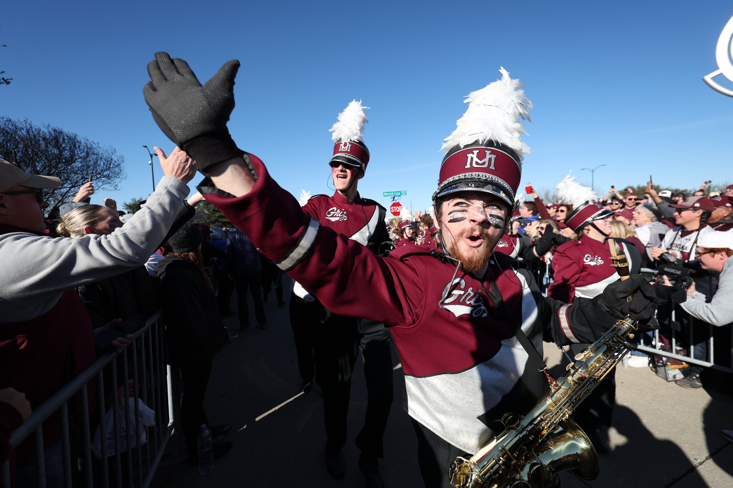  FRISCO, TEXAS - JANUARY 7: A Montana Grizzlies band member high-fives fans before the game against the South Dakota State Jackrabbits during the Division I FCS Football Championship held at Toyota Stadium on January 7, 2024 in Frisco, Texas. (Photo 
