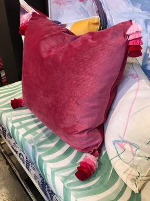 This beautiful pillow at Design Legacy with very special graduated pink tassel trim on the corners.