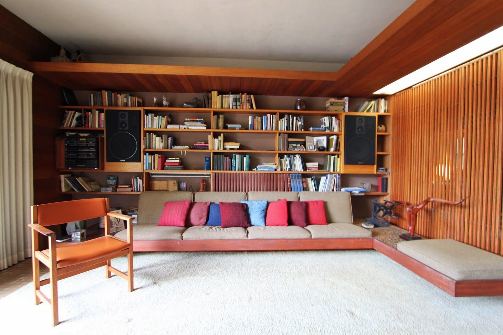 Bookcase design with built-in sectional sofa .