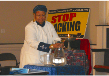 Rev. Monica Beasley-Martin conducting a blessing of Ohio waters at a FaCT meeting