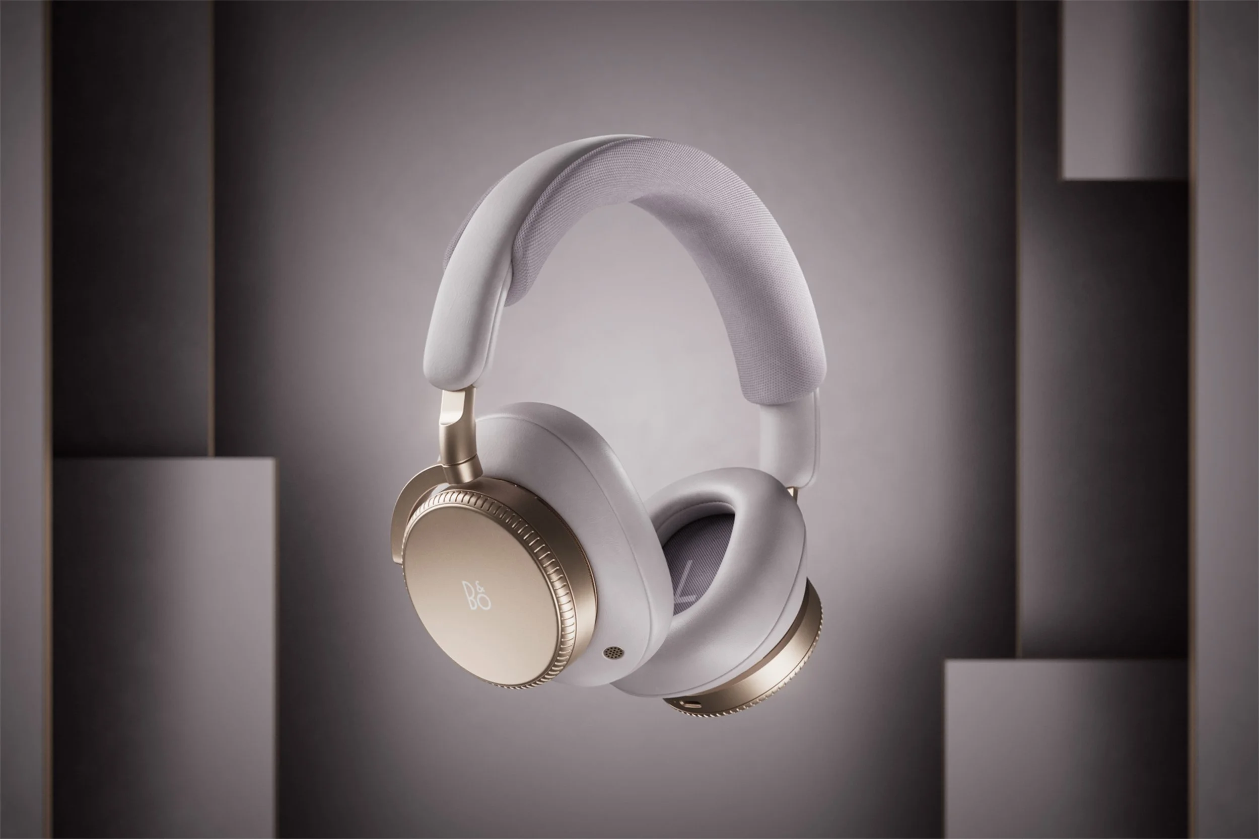 Hourglass Sand Bang and Olufsen, headphones floating against a pink background.