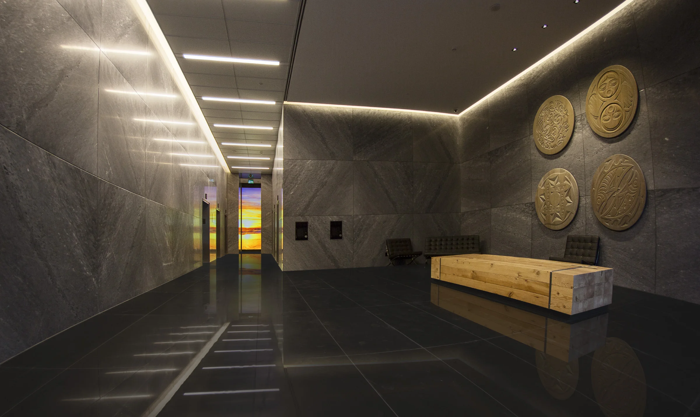 Glowing in the distance, a monumentally sized video installation adds depth and texture to the space.