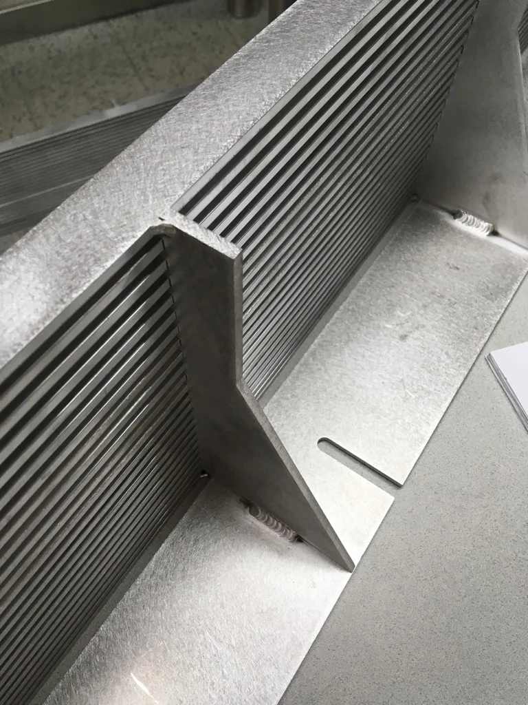 We generally design and fabricate custom vent grilles for our video walls to ensure adequate air circulation, and to optimize the positioning of the screens relative to the surrounding sight lines. These grilles are ready for powder-coating.
