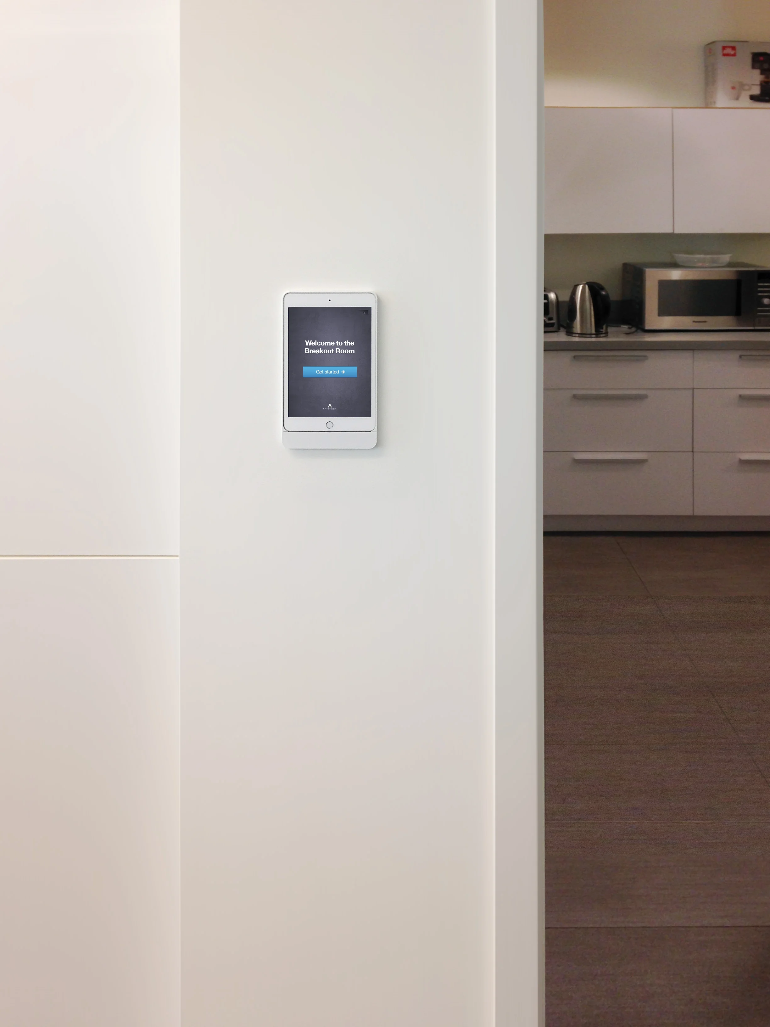 iPads in Basalte Eve® wall mounts greet guests as they enter the various outfitted rooms throughout this space.