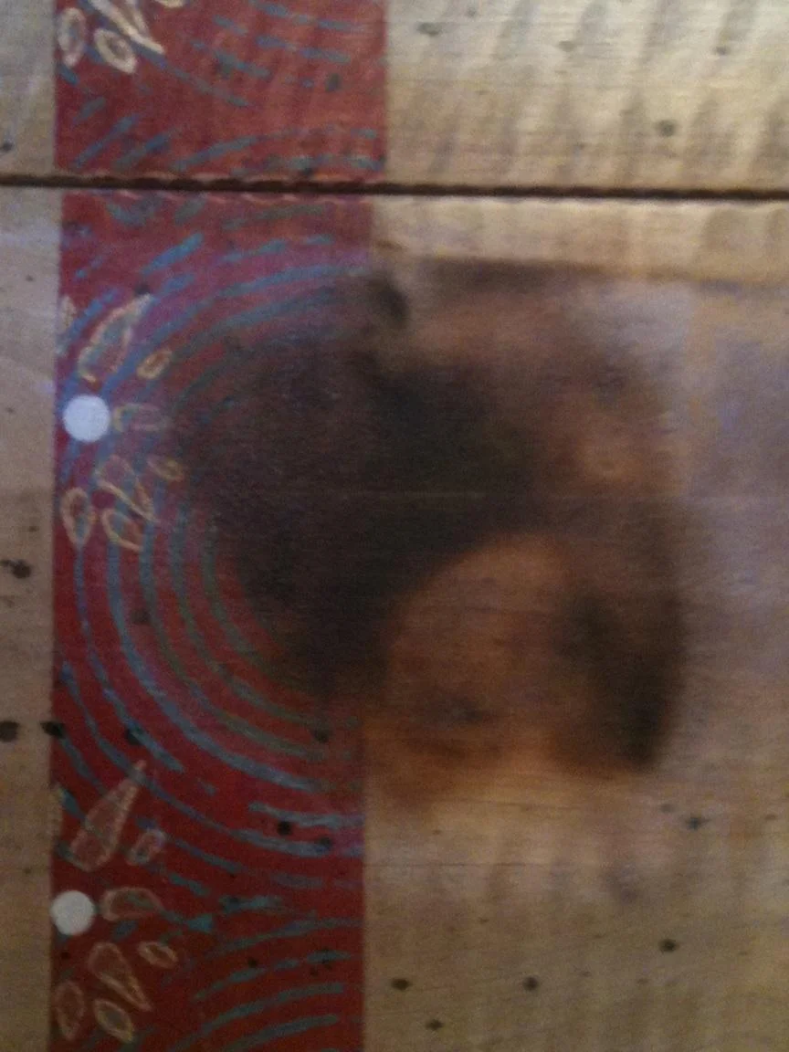 Mother Goose hand painted table burnt by melted candle. Table was in flames before she noticed it had melted through the candle base