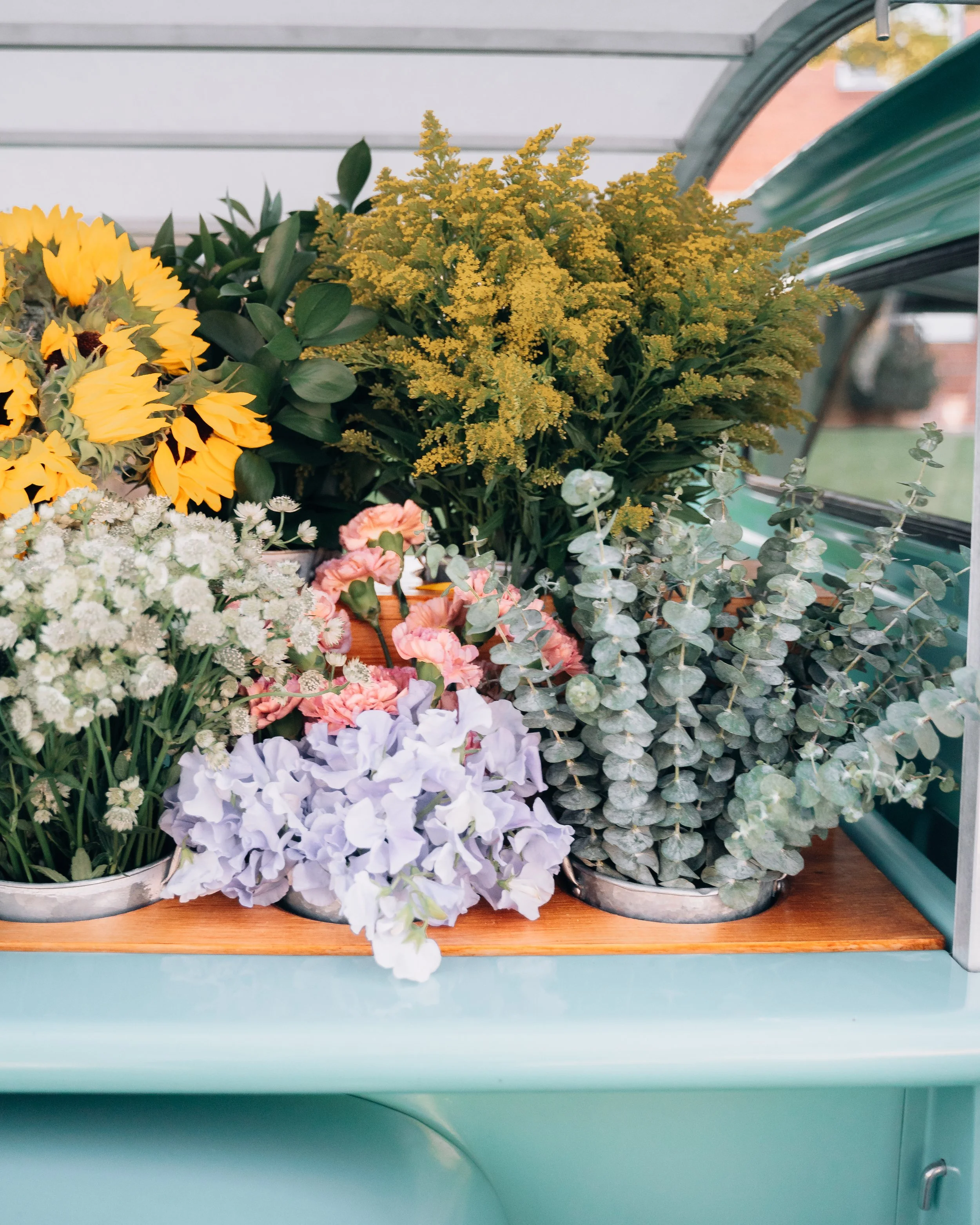 Flowers in steel buckets
