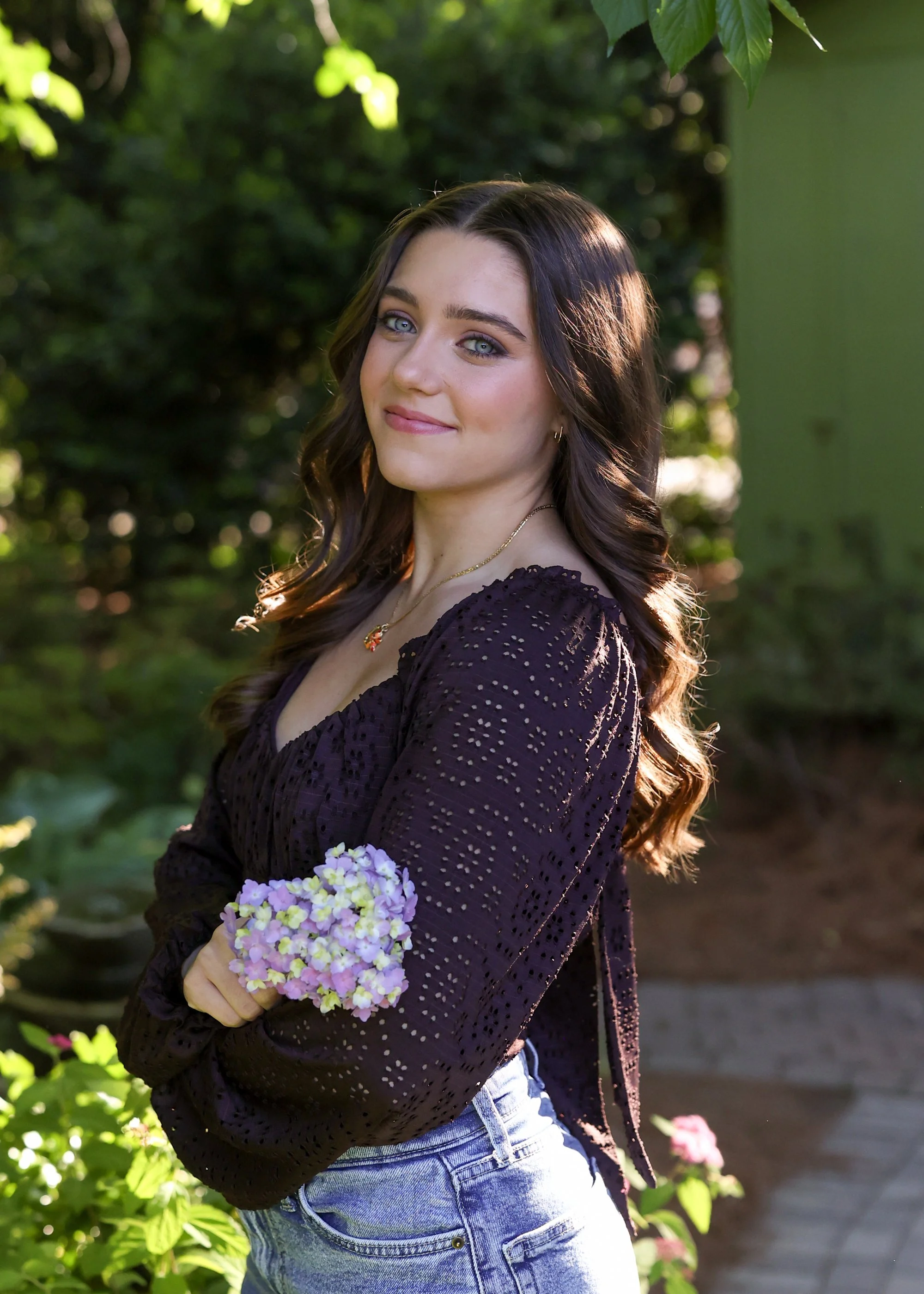 Confident high school senior posing for fall senior pictures with a Raleigh photographer