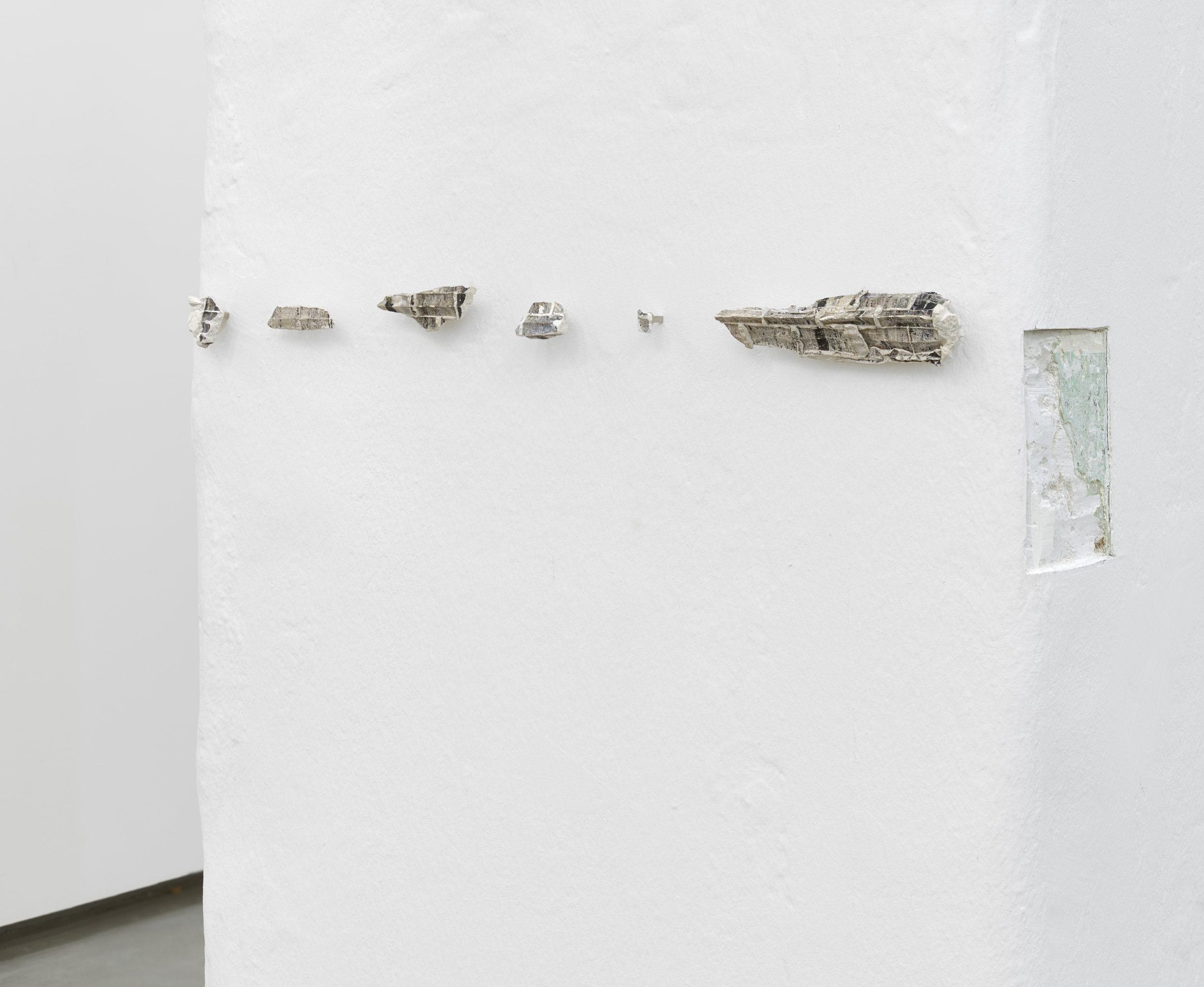    Patterns of a drifting list,     2016  carved wall, plaster and transferred photo  dimensions variable 