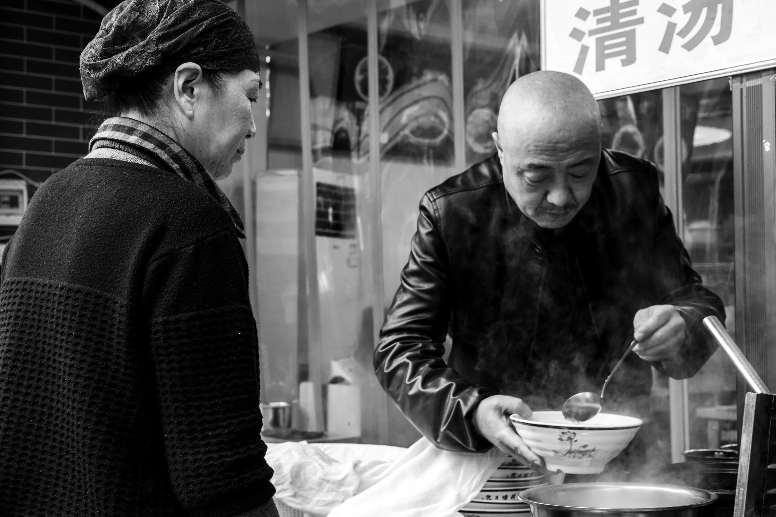 Xi’an ‘Muslim Quarter’ street vendor prepares Beef Stew served with Pita - China, 2020
